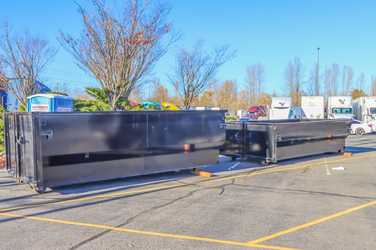 Professional dumpster rental service with roll-off container on residential driveway in Rib Mountain